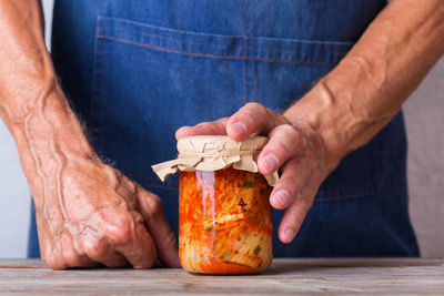 Close-up of man holding ice cream on table