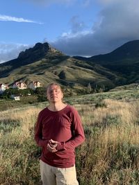 Full length of man standing on field against sky