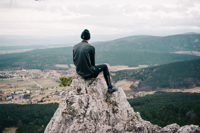 Full length of woman standing on mountain landscape