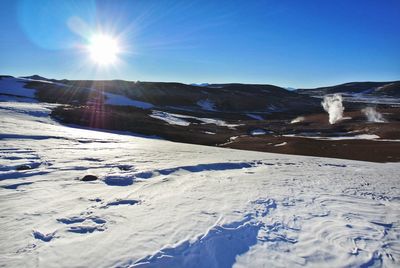 Scenic view of snowcapped mountains against clear sky during winter