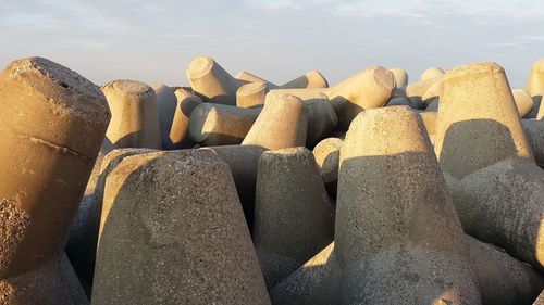 Close-up of rocks on beach against sky