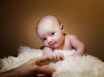 Portrait of cute baby boy against wall at home