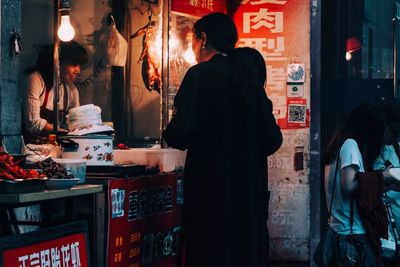 Rear view of people standing in store