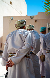 Rear view of people standing in temple