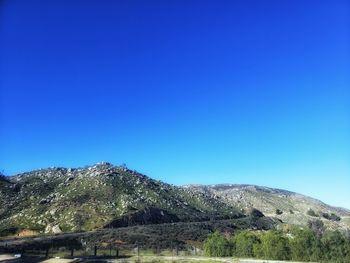 Scenic view of mountains against clear blue sky