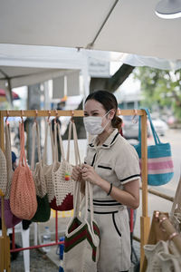 Series photo of young women choosing new shopping bag in street market , refreshing look concept