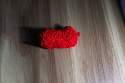 Close-up of red rose on table at home