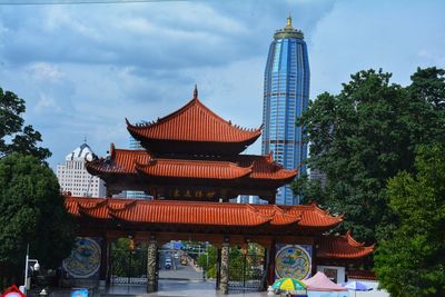 Low angle view of pagoda against sky in city