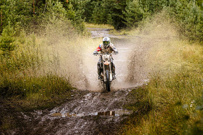 Man riding motorbike in forest