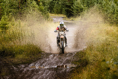 Man riding bicycle in water