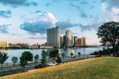 Scenic view of river by buildings against sky