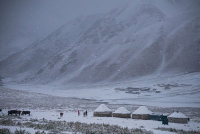 Scenic view of snow covered land and mountains