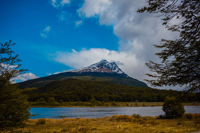 Scenic view of lake by mountain against sky