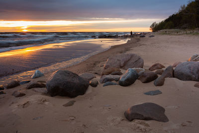 Scenic view of beach against sky during sunset