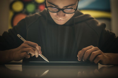 Teenager drawing with tablet and virtual pen. student doing homework with new technology devices. 