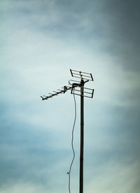 Low angle view of electricity pylon against sky