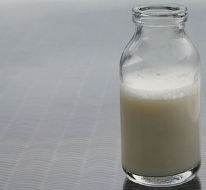 Close-up of milk bottle on table