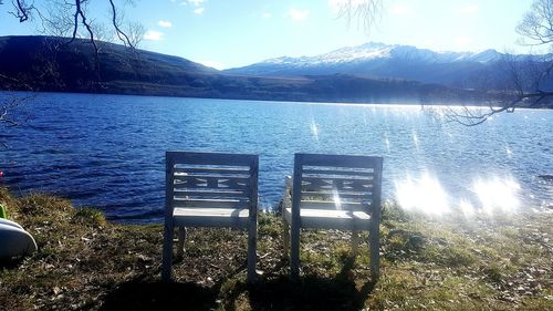 Calm lake with mountains in background