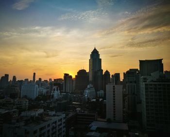 View of cityscape against dramatic sky