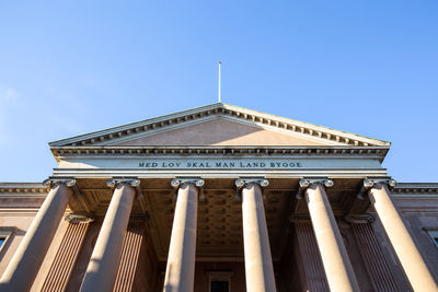 Low angle view of building against clear blue sky