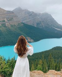 Rear view of young woman looking at valley