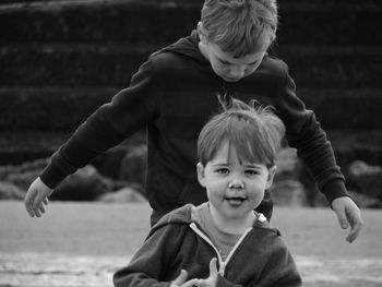 Boy and woman looking at camera