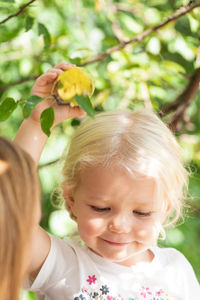 Close-up of cute girl smiling picking fruit