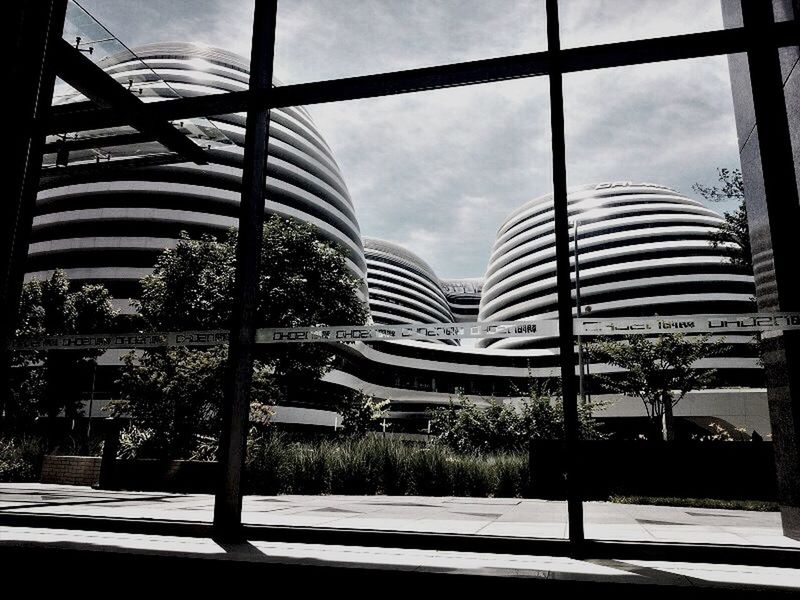 architecture, built structure, building exterior, sky, city, modern, glass - material, cloud - sky, office building, building, day, window, cloud, skyscraper, sunlight, indoors, chair, tree, city life, table