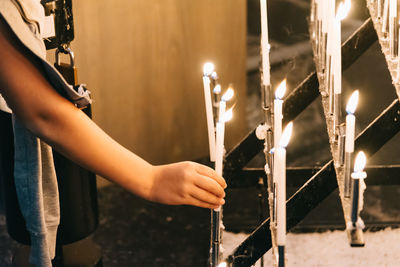 Close-up of hand with church candles