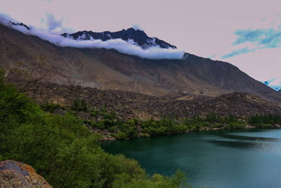 Scenic view of lake and mountains against sky