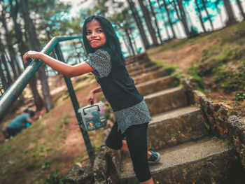 Cute smiling girl standing on steps