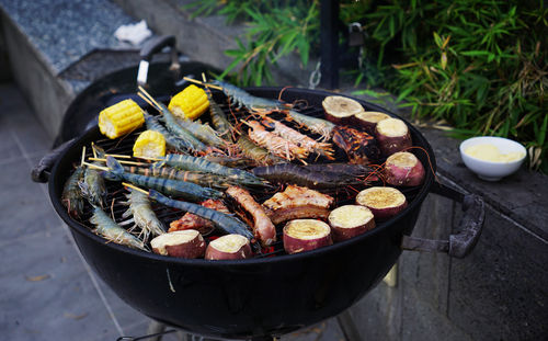 Fresh seafoods and vegetables on a barbecue grill for outdoor party