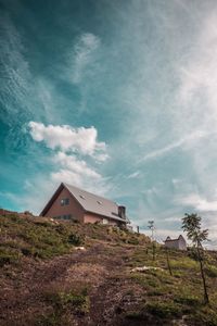 House amidst trees and buildings against sky