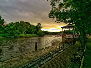 Cars parked on riverbank at sunset