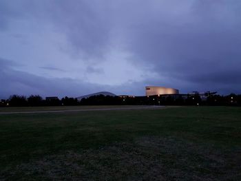 Built structure on field against cloudy sky