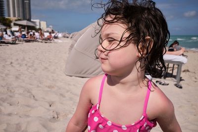 Side view of young woman standing at beach