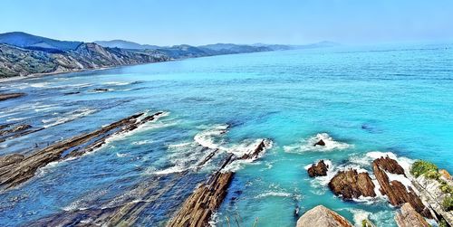 Scenic view of sea against blue sky