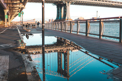 Bridge over swimming pool by sea against sky