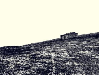 Low angle view of building on field against clear sky