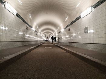 People walking in subway tunnel