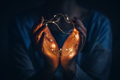 Close-up woman holding led lights