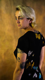 Young man standing against wall