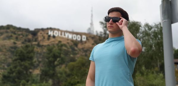 Young man wearing sunglasses standing outdoors
