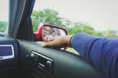 Cropped image of woman driving car