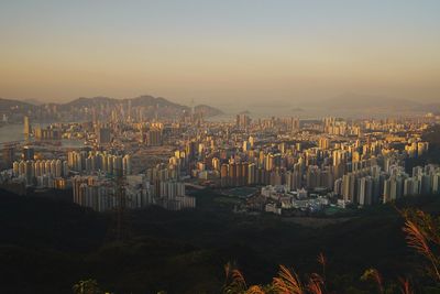 High angle view of buildings in city at sunset