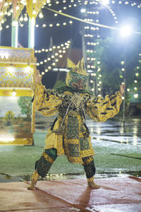 Rear view of woman standing by fountain