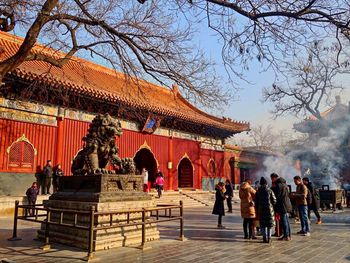 Group of people outside temple against building