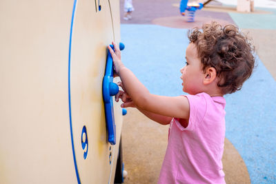 Side view of cute girl standing in playground