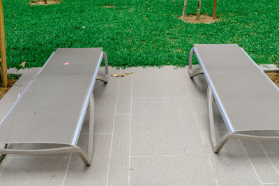 High angle view of empty chair in yard