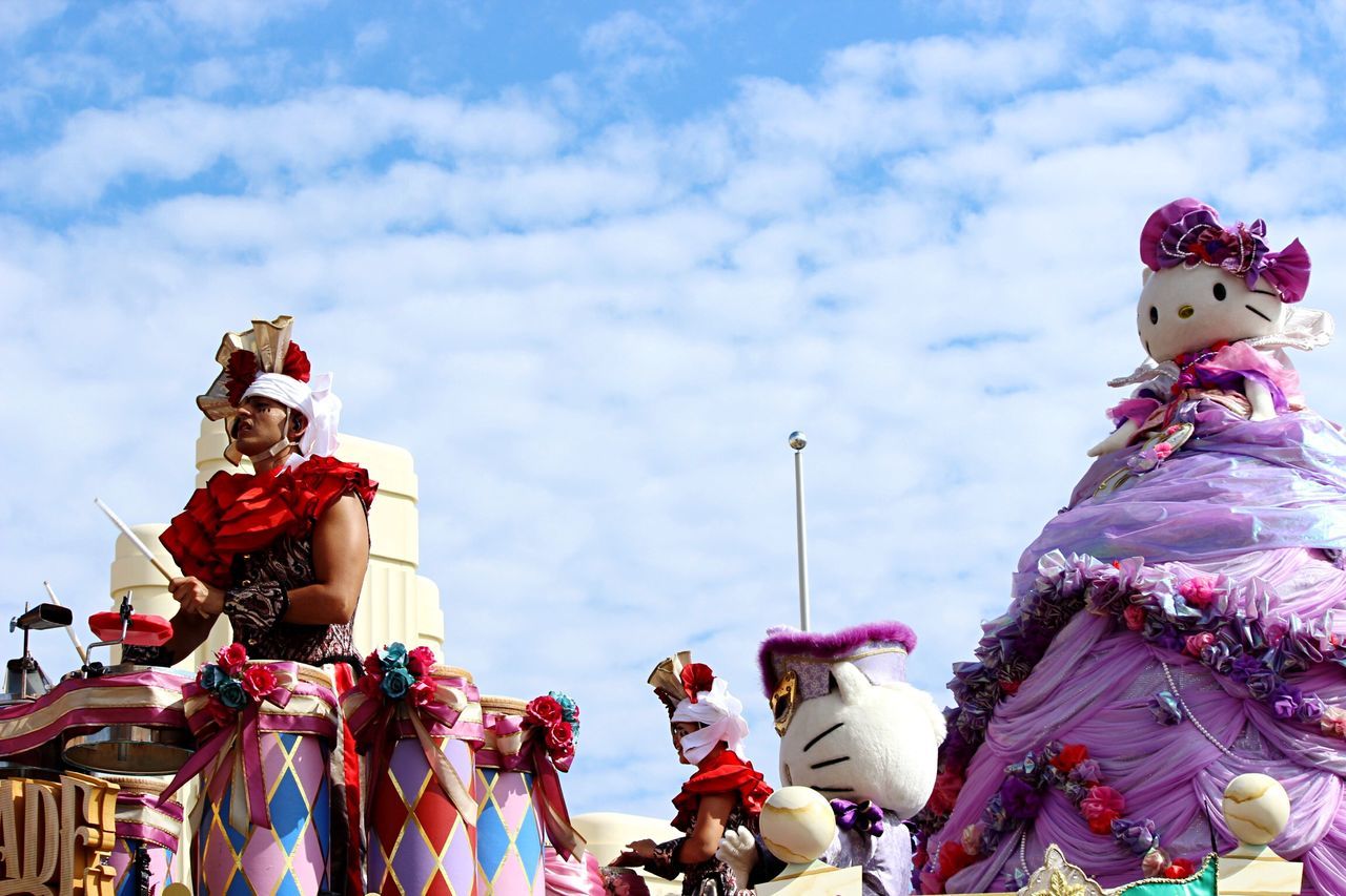 sky, low angle view, human representation, cloud - sky, art and craft, multi colored, art, cultures, cloudy, arts culture and entertainment, leisure activity, amusement park, tradition, celebration, sculpture, creativity, cloud, day